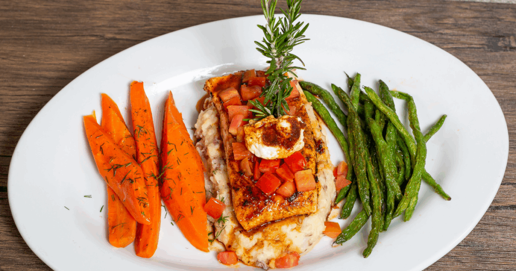 A Guide to Healthy Eating at Hash House A Go Go at The Plaza 1 Grilled salmon with carrots, green beans, and mashed potatoes at Hash House A Go Go—one of the best healthy dishes at The Plaza Las Vegas.