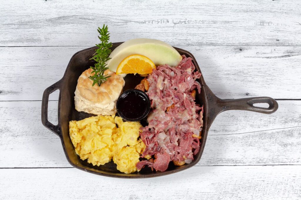 Rise and Shine: The Best Breakfasts at Hash House A Go Go at The Plaza 1 The best skillet hash breakfast in Las Vegas, served at Hash House A Go Go in a cast iron skillet with eggs, biscuit, and rosemary garnish.