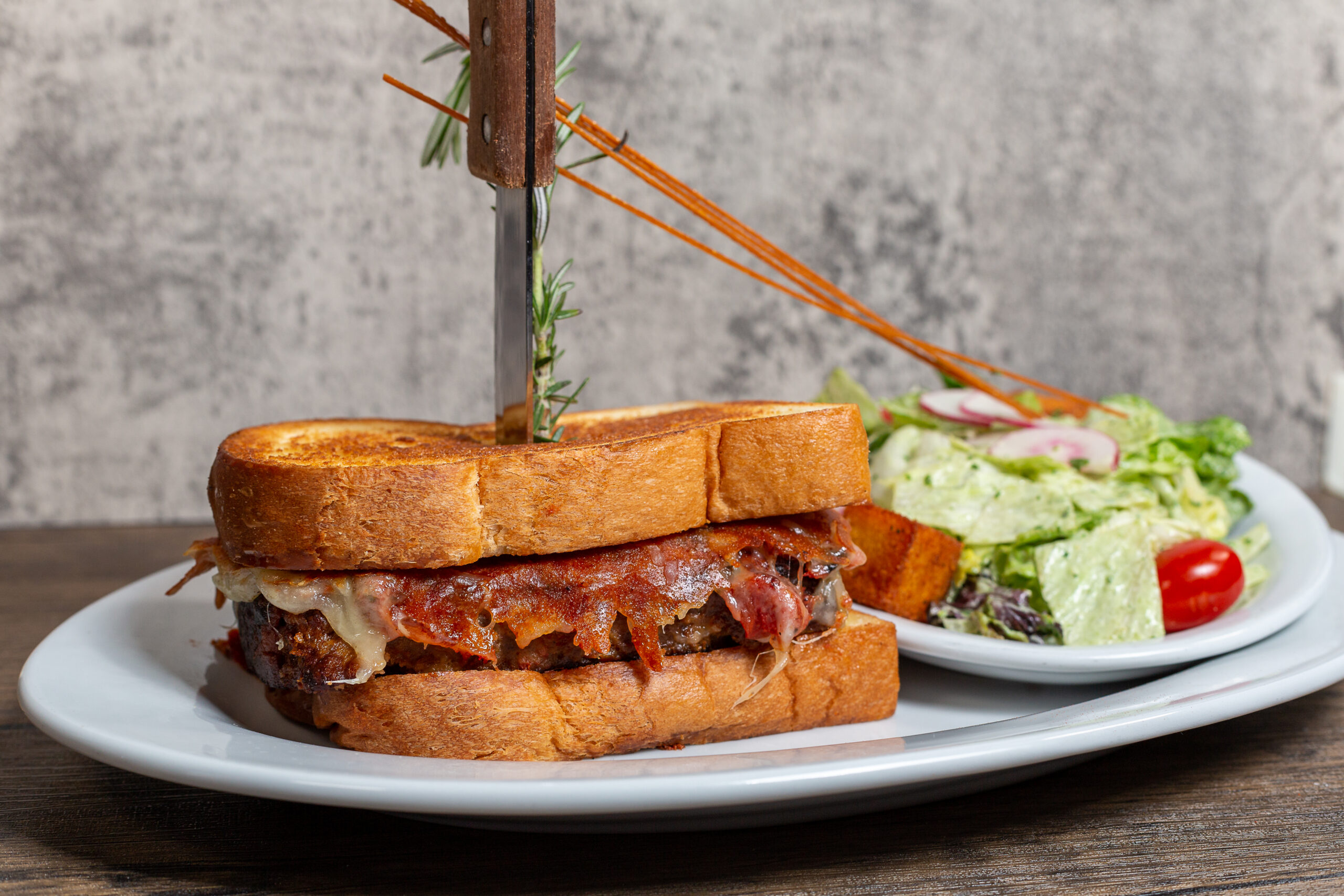 Kokomo Sandwich at Hash House A Go Go Downtown Las Vegas served with fresh side salad – oversized comfort food favorite on Fremont Street for true food lovers.